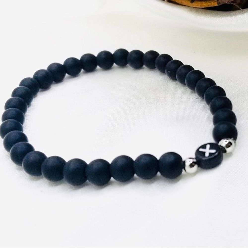Black beaded stretch elastic cord letter X bracelet.